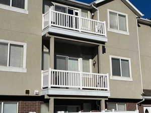 Exterior space with ac unit and a balcony