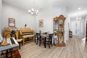 Dining space featuring light hardwood / wood-style floors and an inviting chandelier