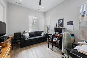 Office space with light hardwood / wood-style flooring and ceiling fan