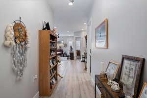 Corridor with light hardwood / wood-style floors
