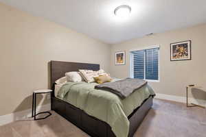 Carpeted bedroom featuring a textured ceiling