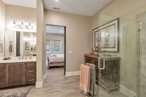 Bathroom with vanity and a shower with shower door