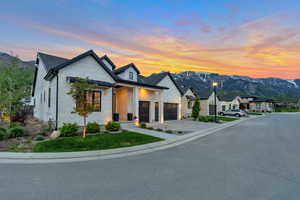 View of front of home with a mountain view and a garage