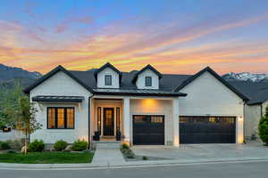 View of front of property with a mountain view and a garage