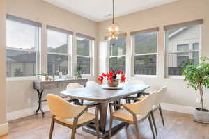 Dining area with a chandelier and light hardwood / wood-style flooring