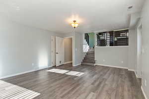 Spare room featuring hardwood / wood-style floors and a textured ceiling