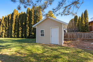 View of outdoor structure with a lawn