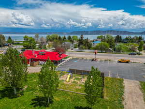 Drone / aerial view featuring a water and mountain view