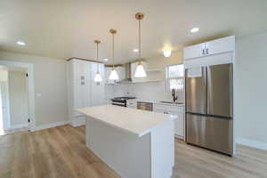 Kitchen featuring white cabinets, sink, and appliances with stainless steel finishes