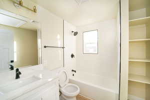 Full bathroom featuring bathing tub / shower combination, vanity, and toilet