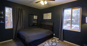 Bedroom featuring ceiling fan and carpet floors