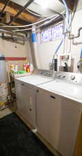 Washroom featuring gas water heater and washer and clothes dryer