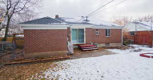 View of snow covered rear of property