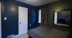 Carpeted bedroom with multiple windows