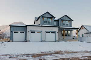 View of front of home featuring a mountain view, a garage, and covered porch