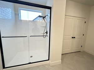 Bathroom featuring tile patterned floors and an enclosed shower