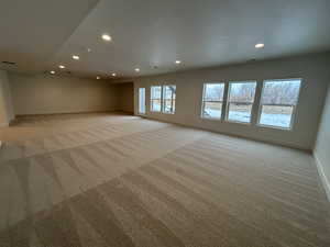 Spare room featuring light colored carpet