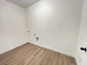 Laundry room featuring washer hookup, electric dryer hookup, and hardwood / wood-style floors