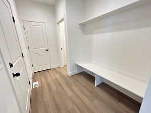 Mudroom with light hardwood / wood-style floors