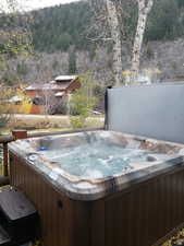 View of swimming pool with a hot tub