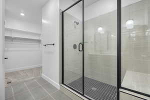 Bathroom featuring an enclosed shower and tile patterned flooring