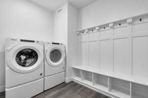 Laundry area featuring separate washer and dryer and dark hardwood / wood-style flooring