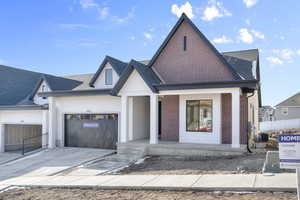 View of front of property with a garage and a porch