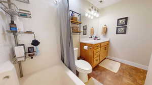 Full bathroom with vanity, toilet, and shower / tub combo with curtain