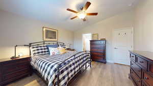 Primary bedroom featuring ceiling fan, light hardwood  / wood-style flooring, ensuite bathroom