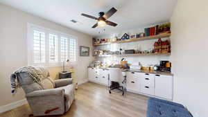 Bedroom 3 used as home office with ceiling fan and light hardwood / wood-style floors