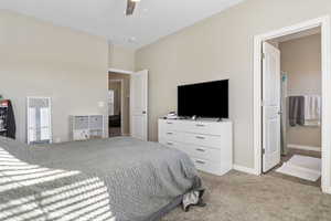 Bedroom with ceiling fan and light colored carpet