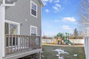 Exterior space featuring a wooden deck and a yard