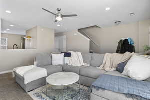 Living room featuring carpet flooring and ceiling fan