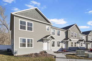 View of front of house featuring central AC