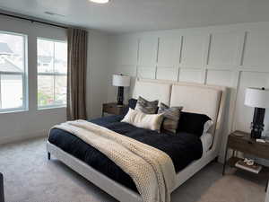 Bedroom with a textured ceiling and carpet floors