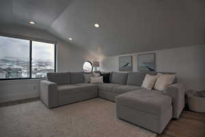 Living room featuring hardwood / wood-style floors and lofted ceiling