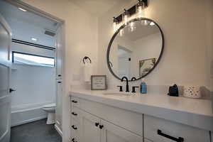 Bathroom featuring tile patterned floors, vanity, and toilet