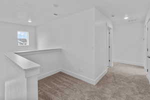 Hallway with light carpet