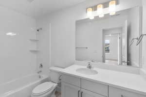 Full bathroom with vanity, toilet, and washtub / shower combination