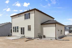 Rear view of house with cooling unit