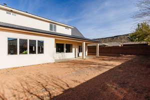 Rear view of property featuring a patio