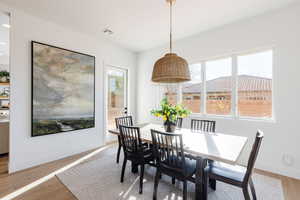 Dining room with light hardwood / wood-style flooring