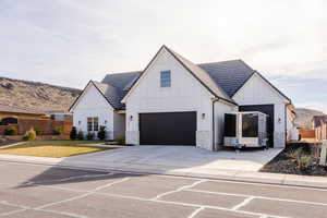 Modern farmhouse style home with a garage and a front yard