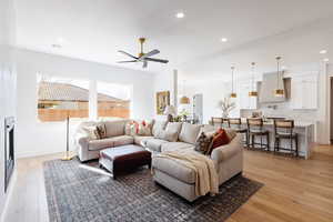 Living room featuring ceiling fan and light hardwood / wood-style floors