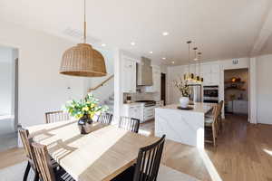 Dining room with light hardwood / wood-style flooring and sink