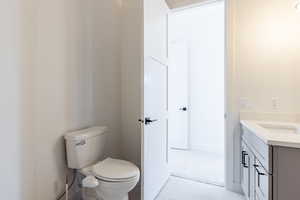 Bathroom with tile patterned floors, vanity, and toilet