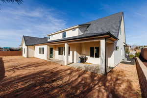 Rear view of house featuring a patio