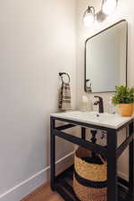 Bathroom with hardwood / wood-style floors and vanity