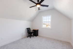 Office with ceiling fan, light carpet, and lofted ceiling