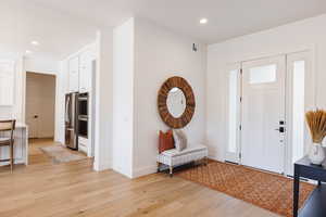 Entrance foyer with light hardwood / wood-style flooring